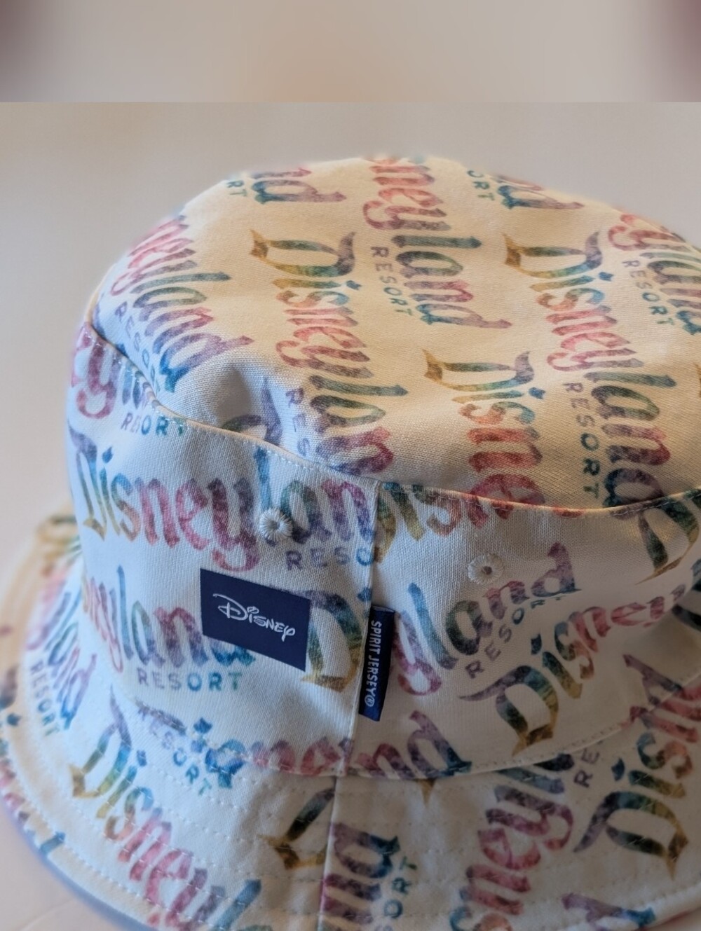 Disney Parks  Adult reversible Tie dyCream Bucket Hat with Multicolor Logo Print